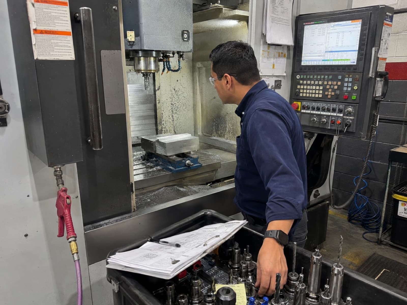 Engineer monitoring a CNC machining center